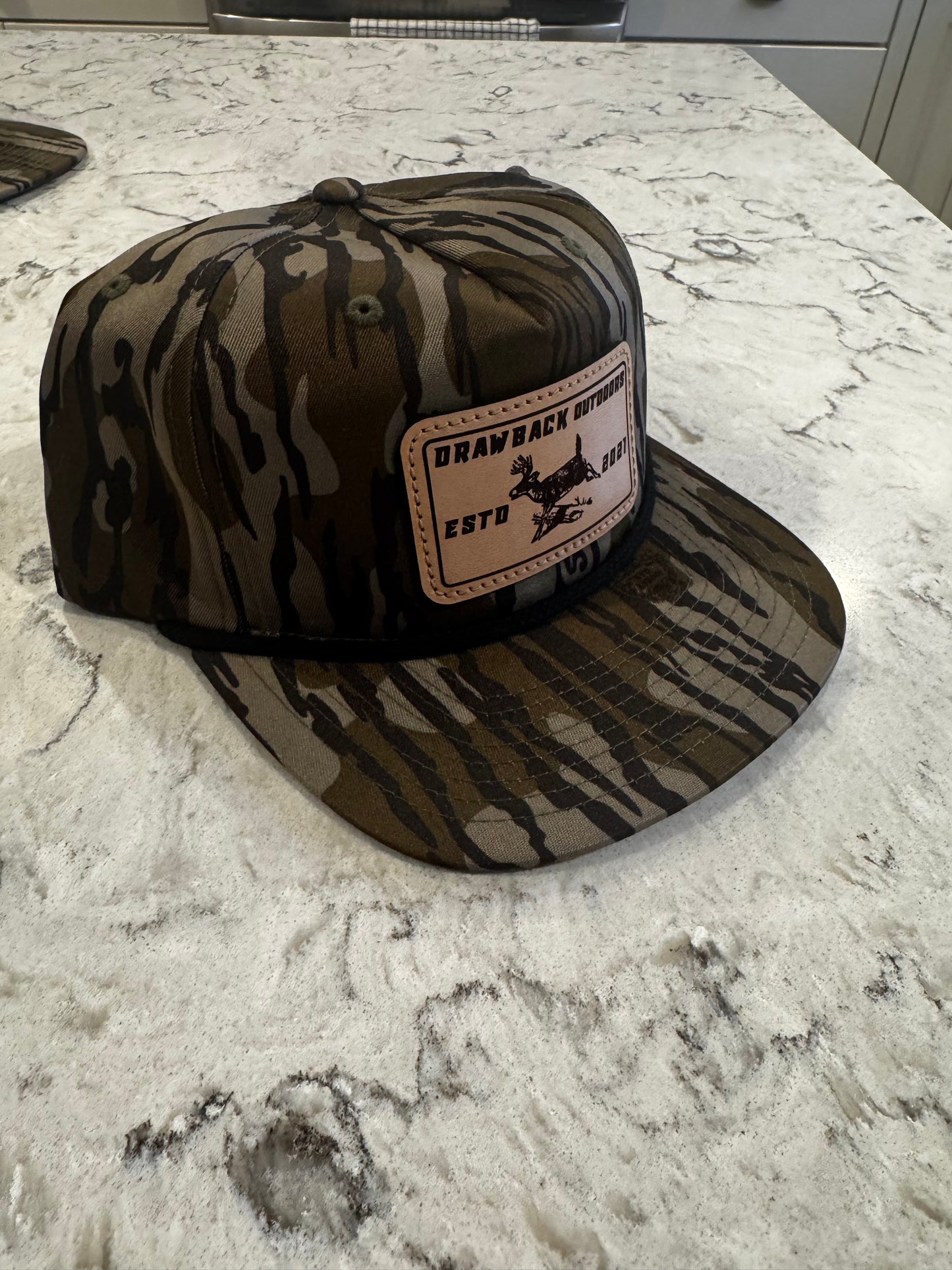 Drawback Outdoors mossy oak whitetail leather patch hat