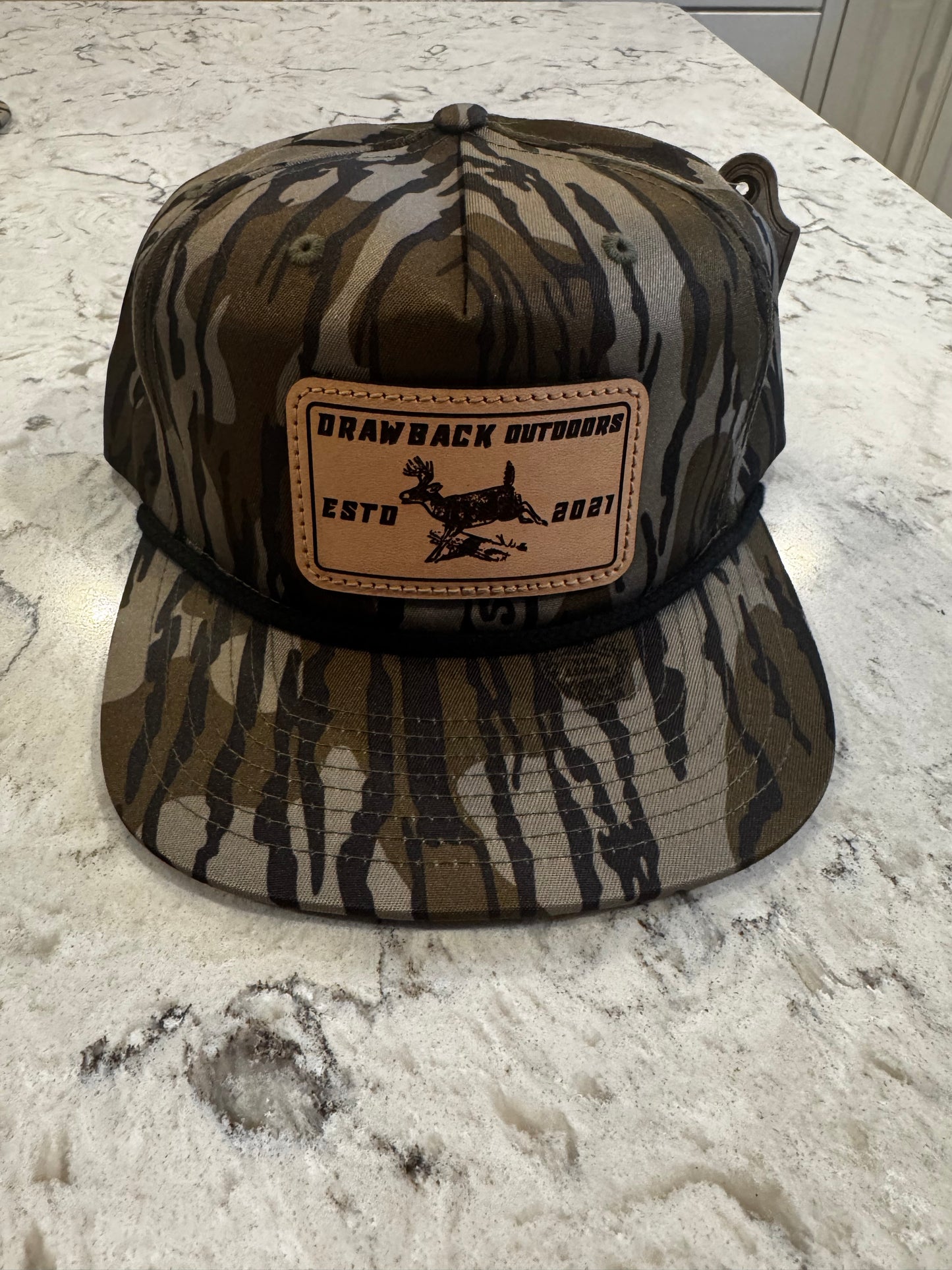 Drawback Outdoors mossy oak whitetail leather patch hat